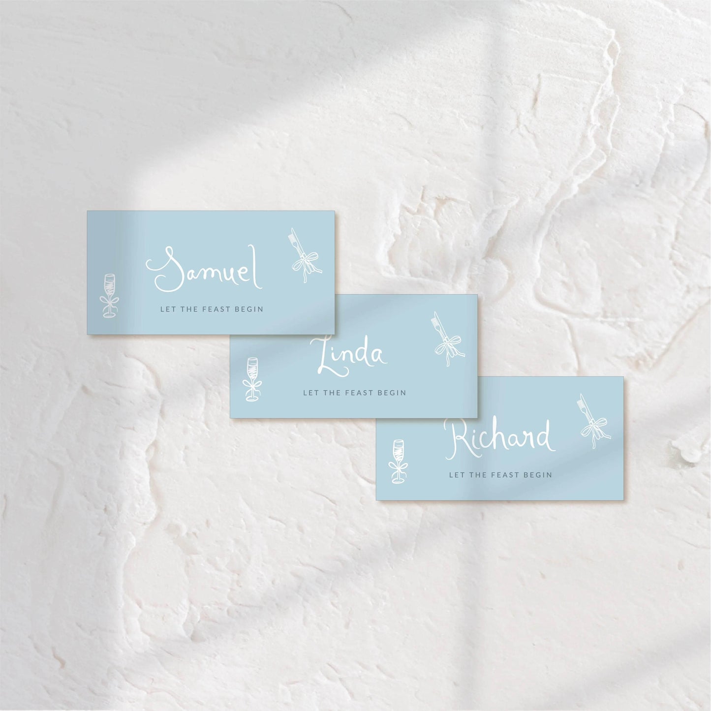 Rectangular blue place cards with elegant white type, ideal for modern table settings.