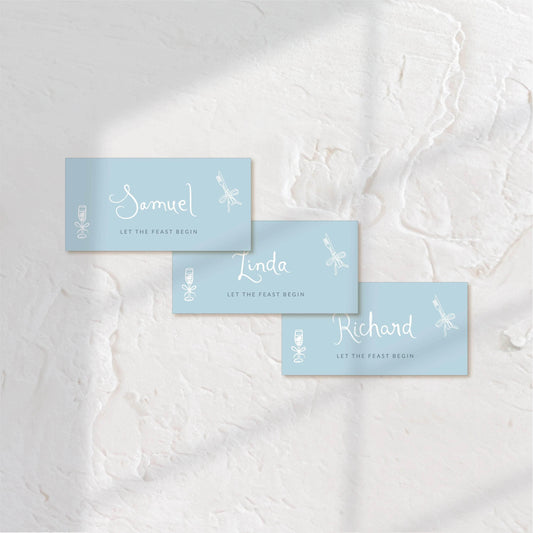 Rectangular blue place cards with elegant white type, ideal for modern table settings.