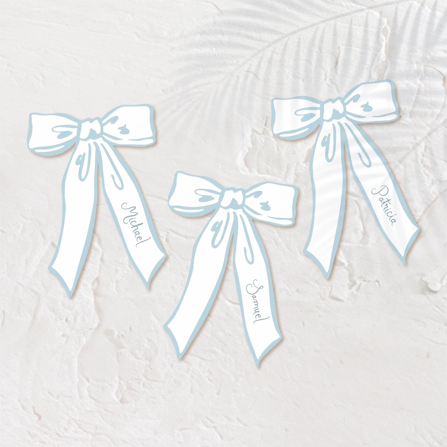 Bow-shaped pastel blue place cards for a playful, elegant wedding setting.