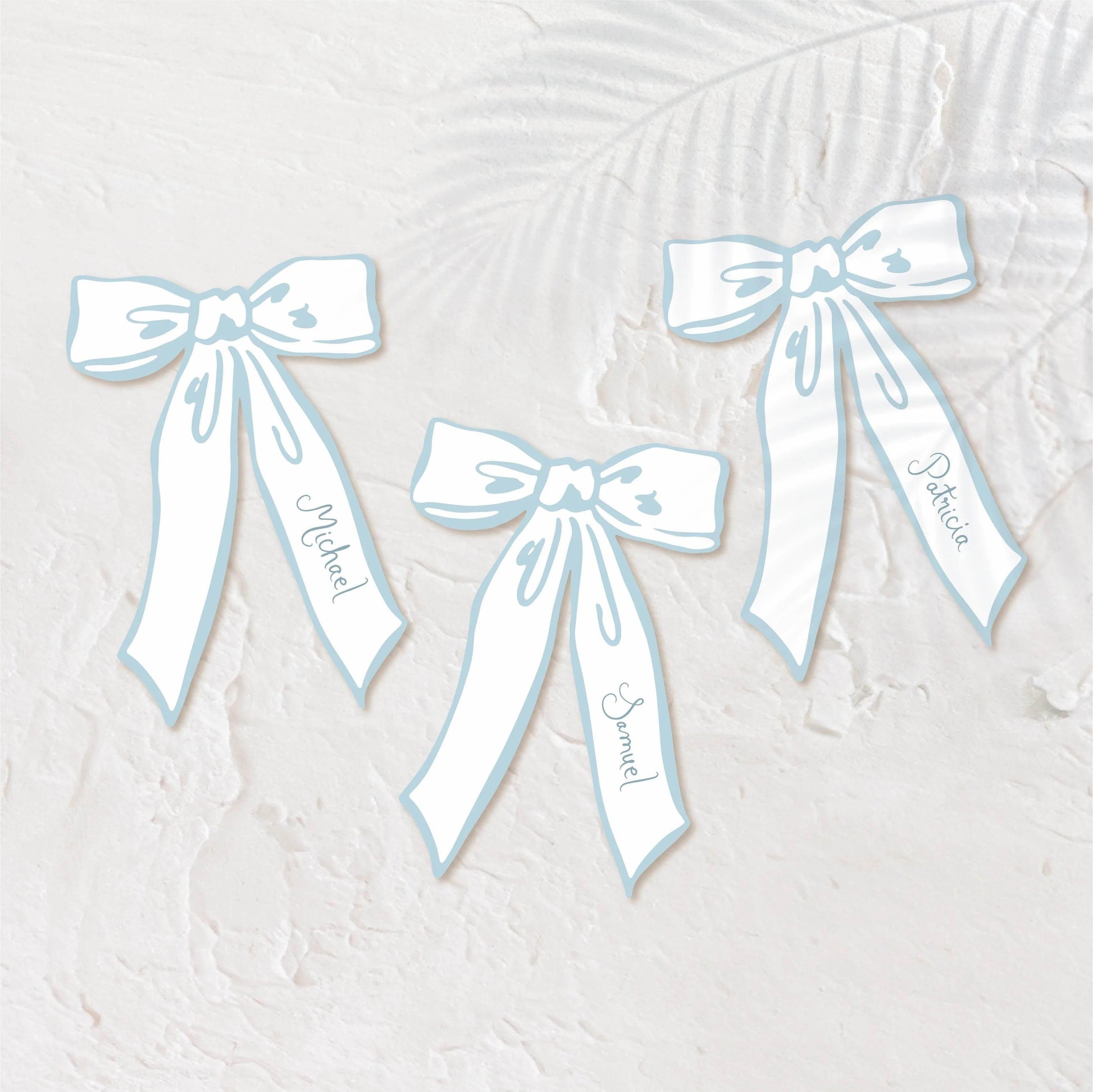 Bow-shaped pastel blue place cards for a playful, elegant wedding setting.
