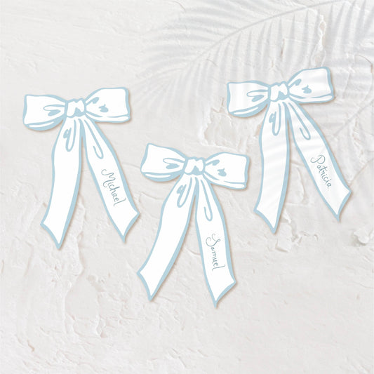 Bow-shaped pastel blue place cards for a playful, elegant wedding setting.