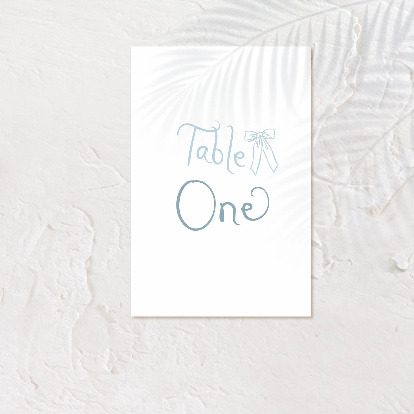 Modern table number card with bold serif text and soft neutral background.