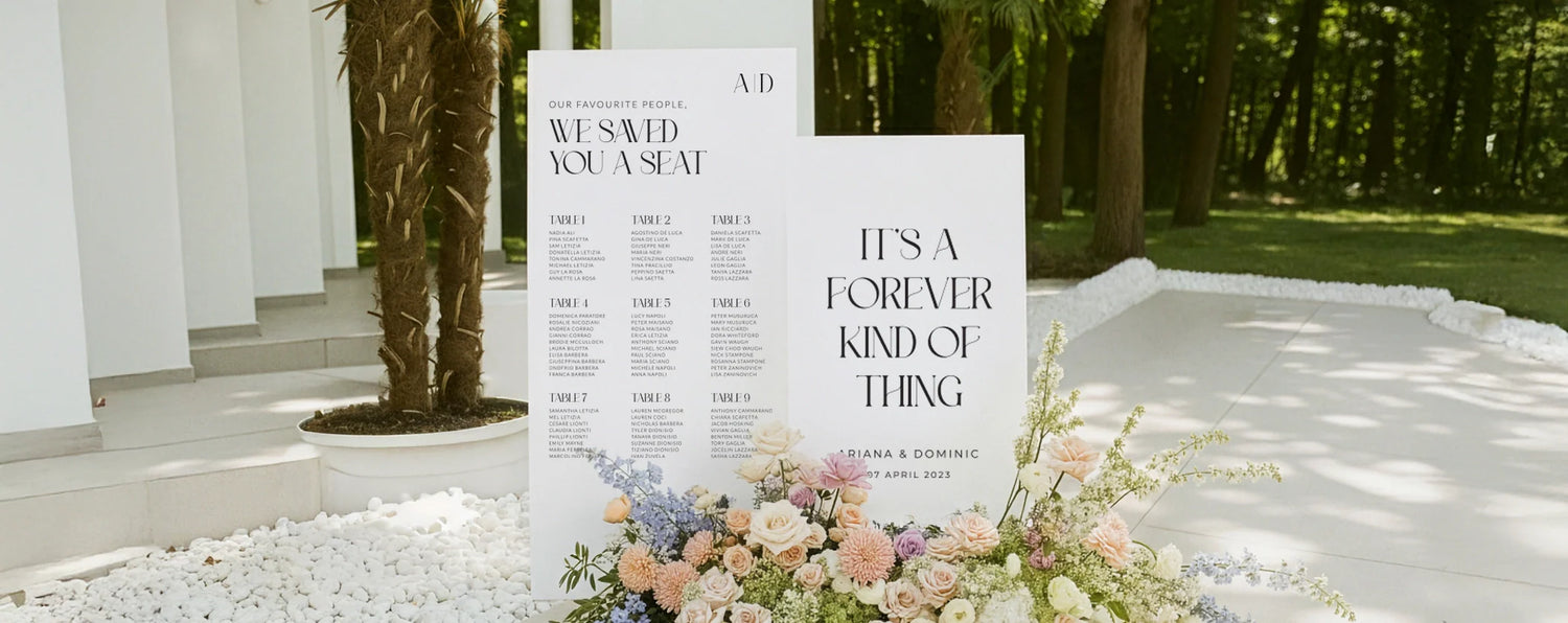 Matching wedding seating chart and welcome sign displayed with pastel flowers