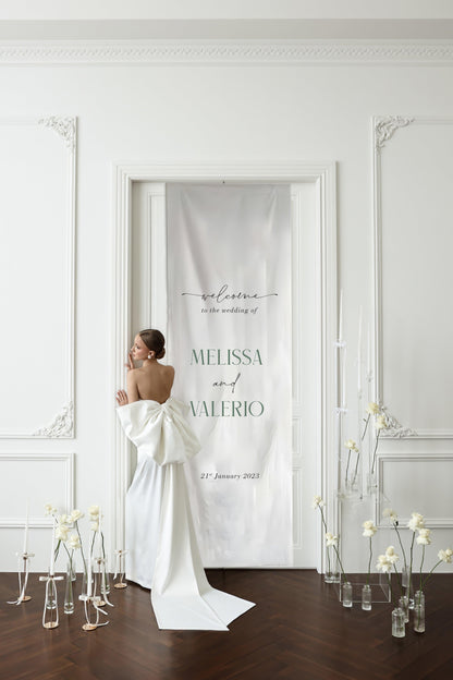 Luxurious fabric wedding sign for Melissa and Valerio, elegantly displayed in a grand white room, creating a timeless and sophisticated statement for their wedding day.